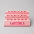 Pink makeup organizer with multiple compartments on a gray background
