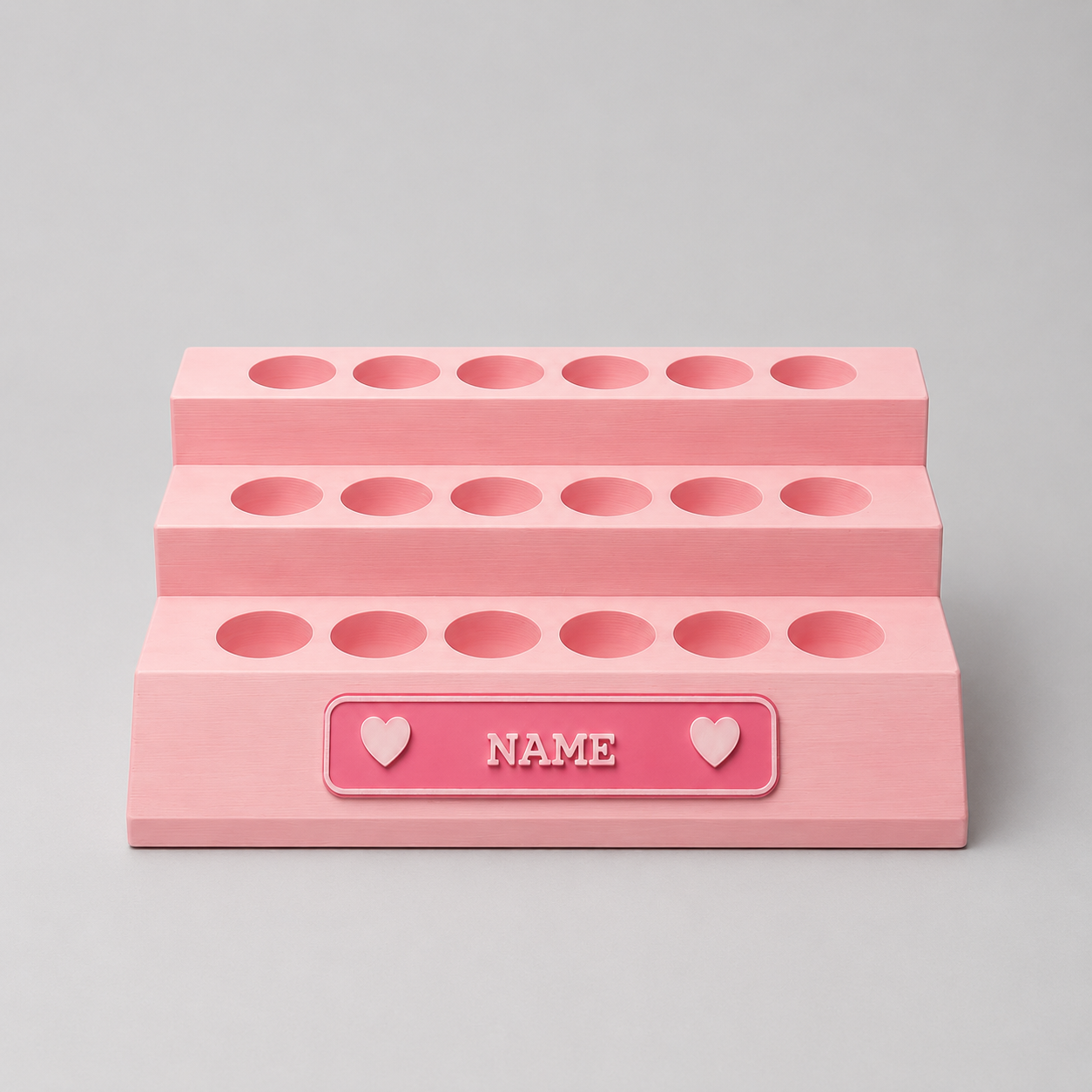 Pink makeup organizer with multiple compartments on a gray background