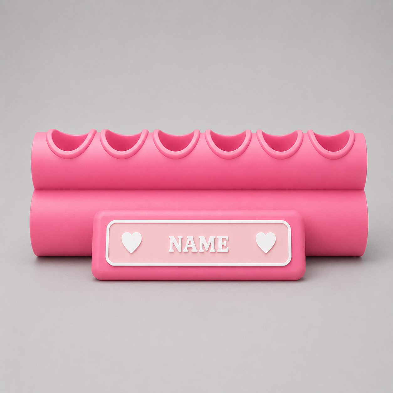 Pink foam roller with customizable name plate on a gray background