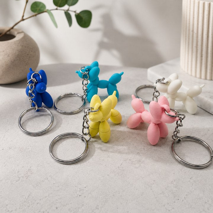 3D printed balloon dog keyrings in blue, teal, yellow, pink and white colours