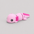 3D printed Teeny Axolotl figure in soft pink with hot-pink gill plumes, lying down