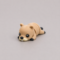 3D printed Teeny Beaver figure in warm sandy brown with black paws, lying down