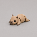 3D printed Teeny Capybara figure in warm sandy brown, lying down