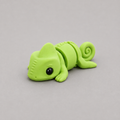 3D printed Teeny Chameleon figure in vivid lime green with curled tail, lying down