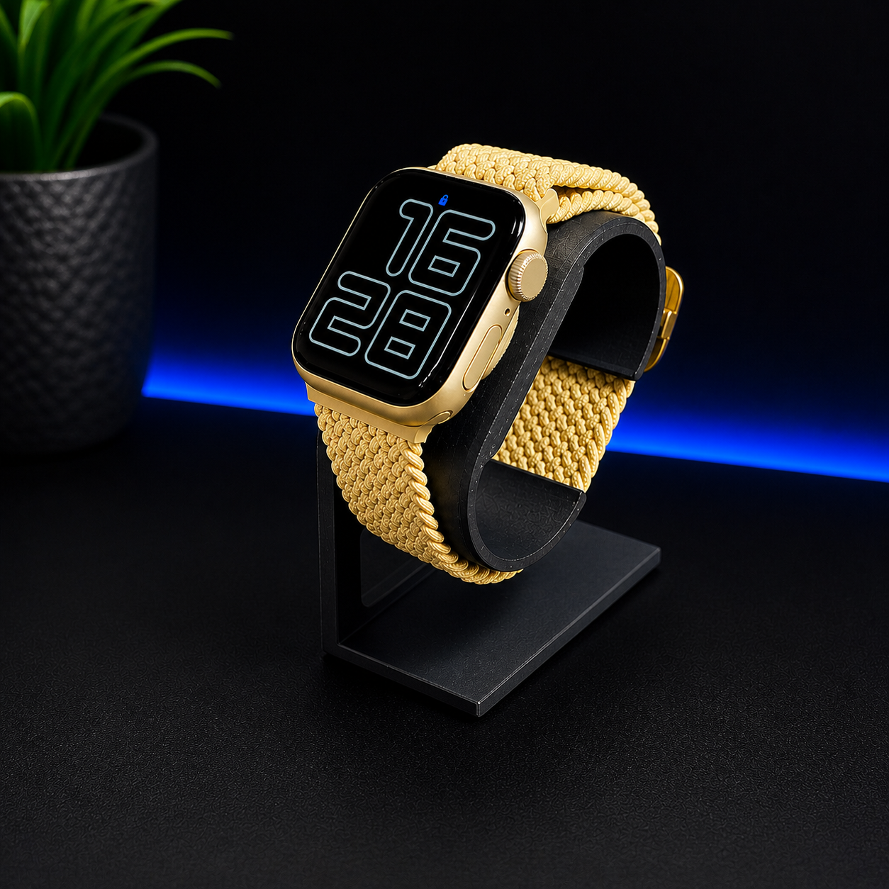 Smartwatch with a yellow braided band on a black stand against a dark background