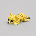 3D printed Teeny Cheetah figure in golden yellow with dark rosette spots, lying down