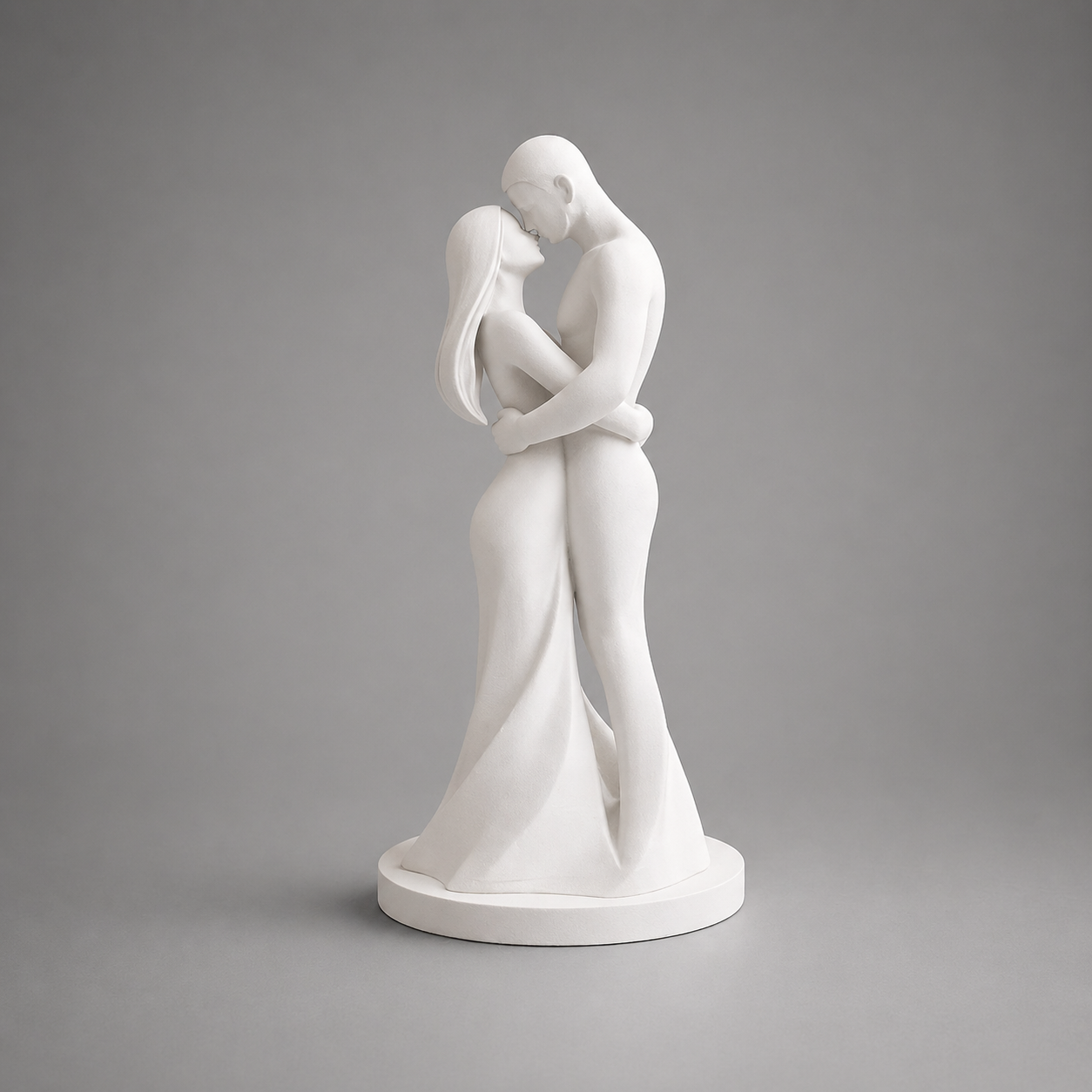 White sculpture of two people embracing on a gray background