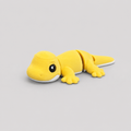 3D printed Teeny Gecko figure in vivid yellow with white underbelly, lying down