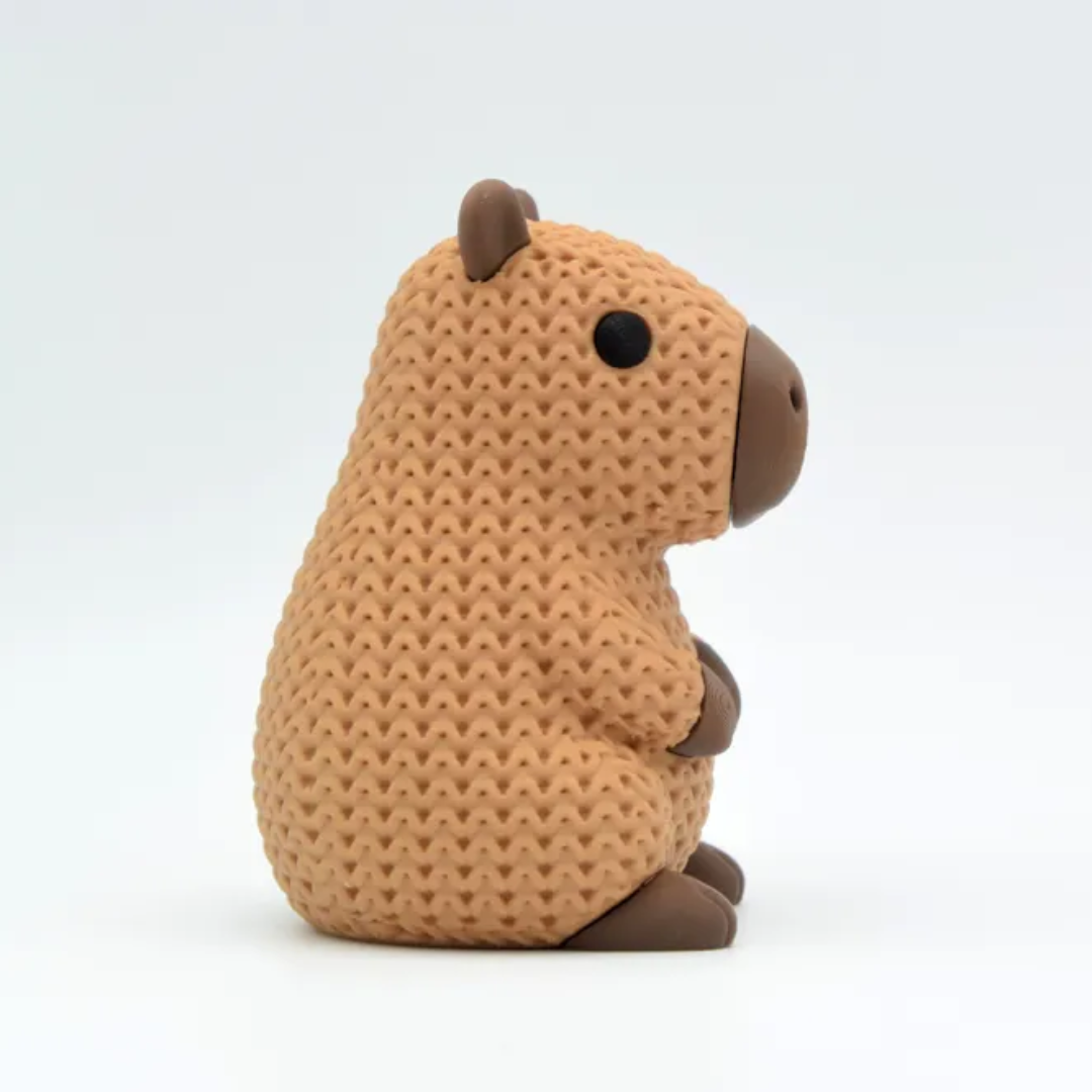 Brown plush toy resembling a rodent on a white background