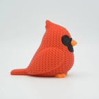 Knitted red bird toy on a white background