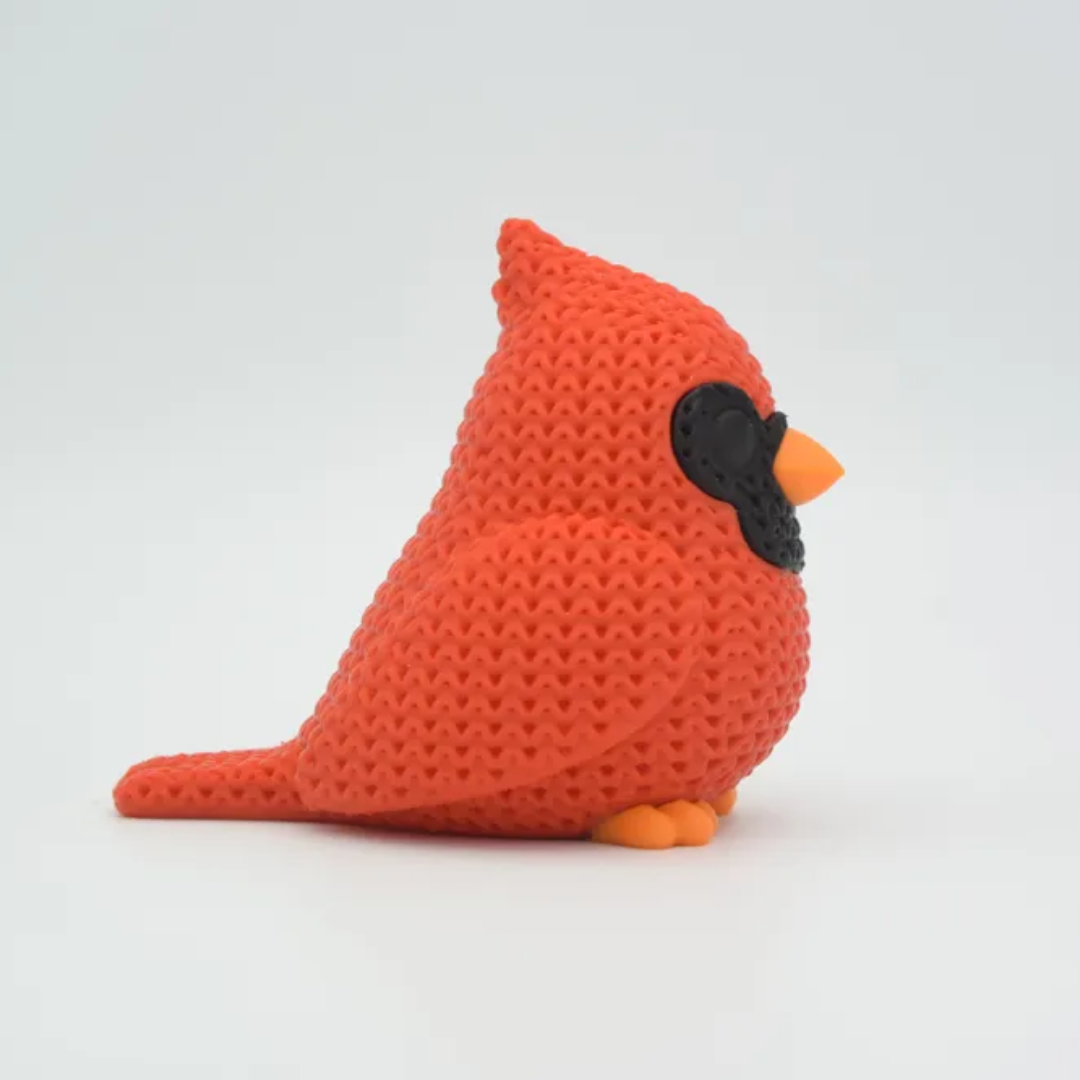 Knitted red bird toy on a white background