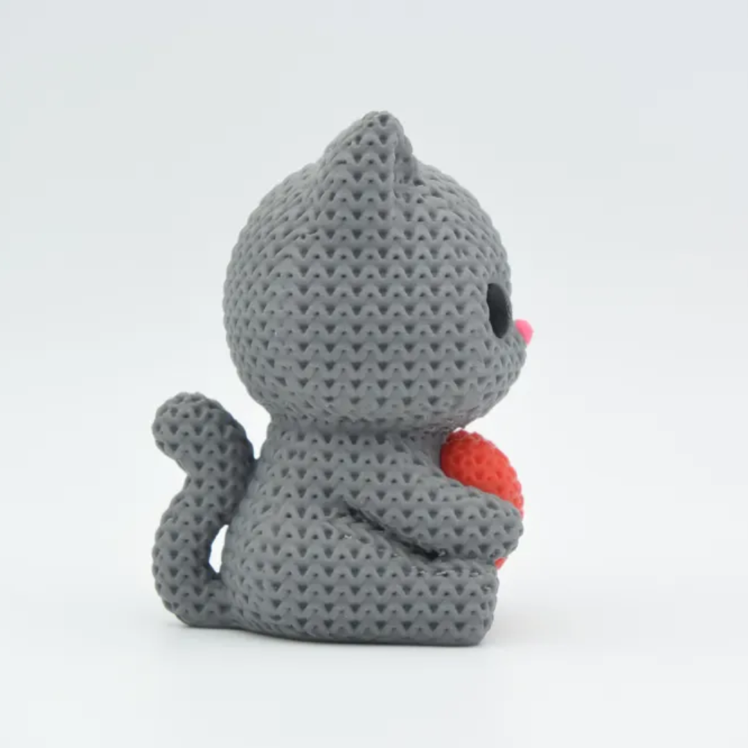 Gray knitted cat toy with a red heart on a white background