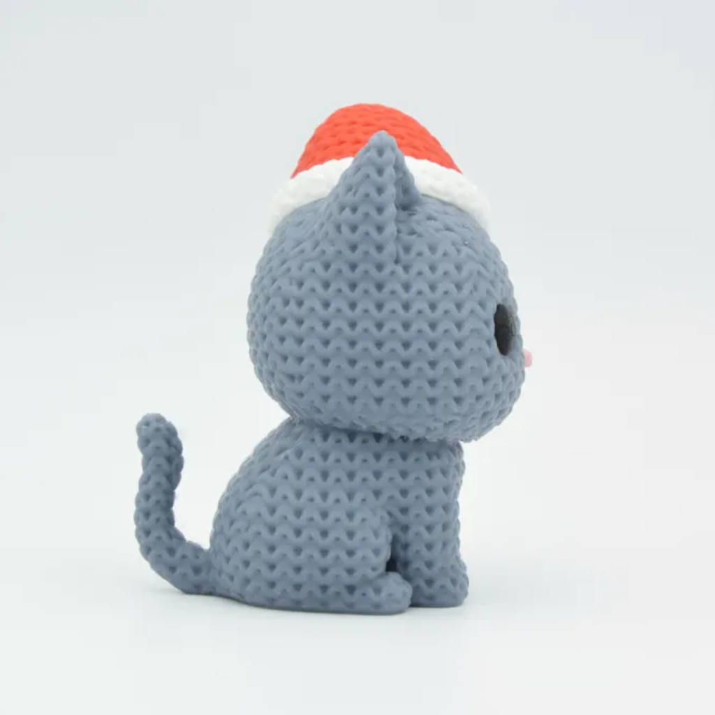 Gray plush cat toy with a red and white hat on a light gray background