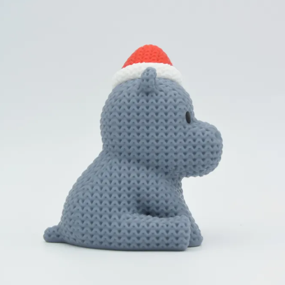 Gray knitted toy with a red and white hat on a light gray background