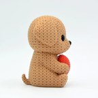 Brown crochet dog holding a red heart on a white background