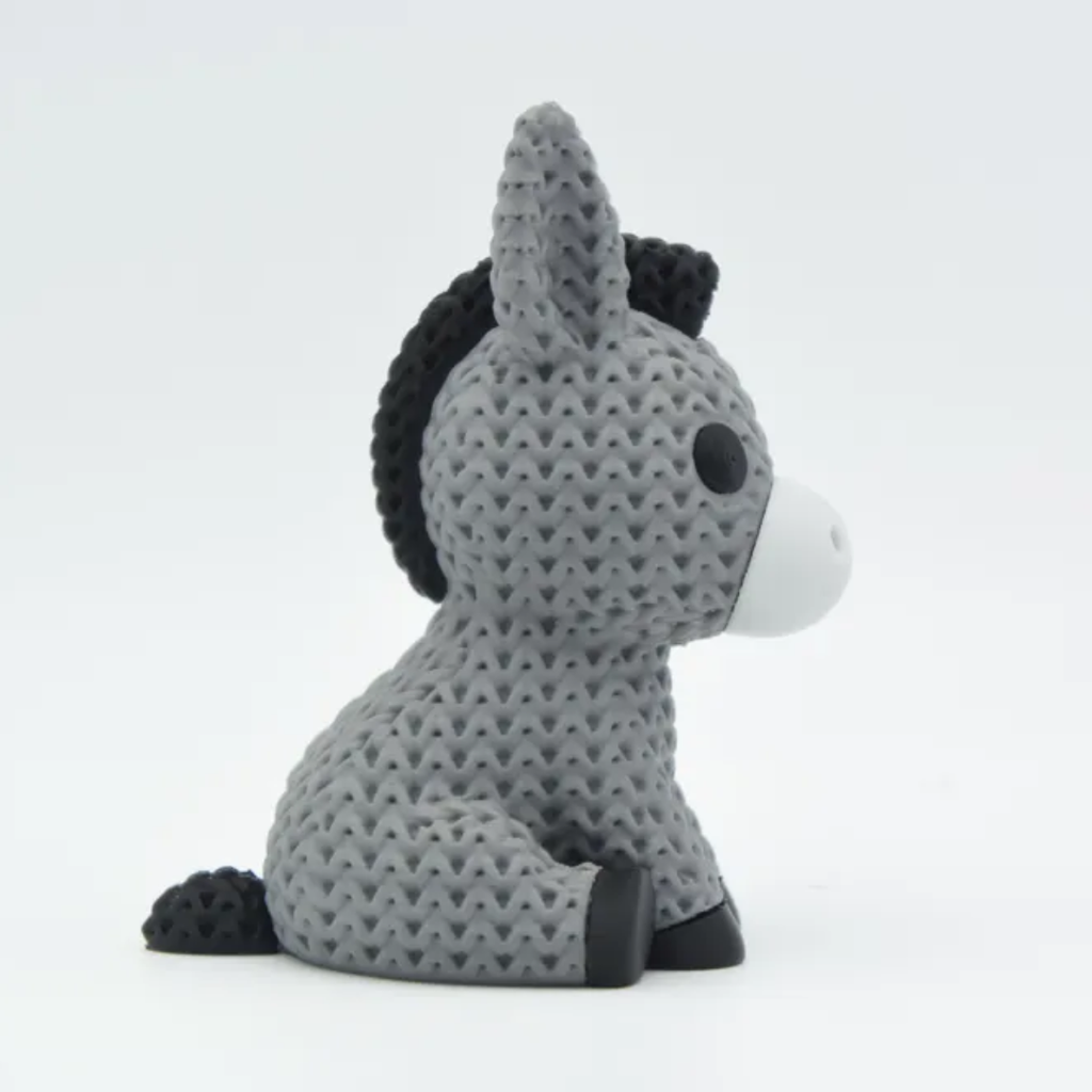 Plush donkey toy with textured pattern on a white background