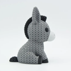 Plush donkey toy with textured pattern on a white background