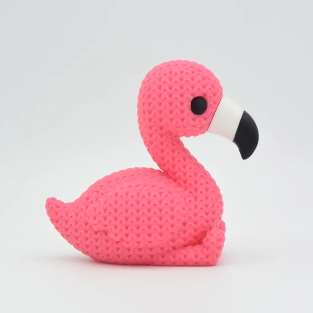 Pink flamingo-shaped toy on a light gray background