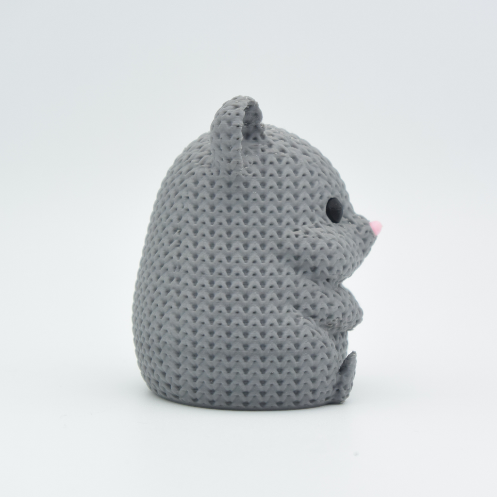 Gray knitted mouse toy on a white background