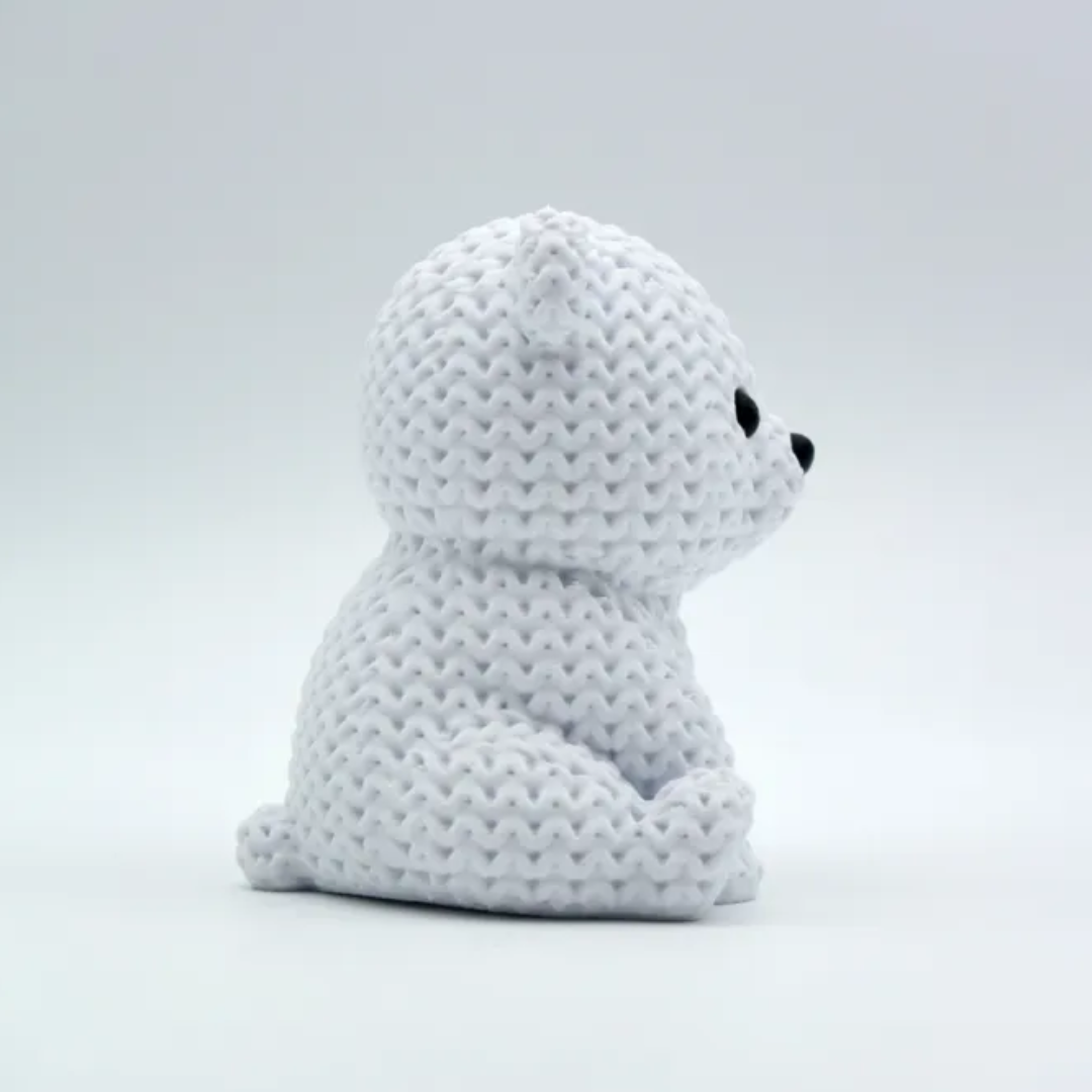 White plush toy with black eyes on a light gray background