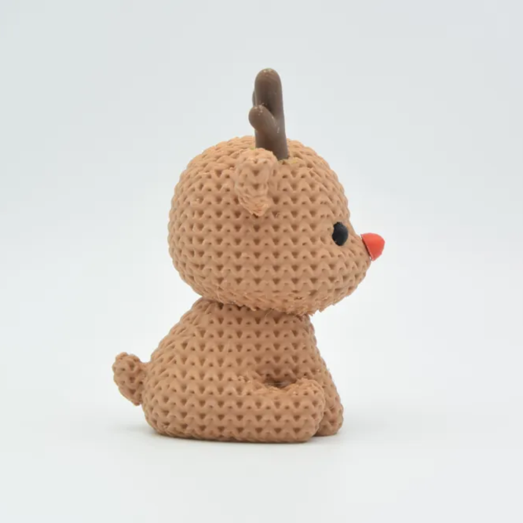 Brown knitted reindeer toy on a white background