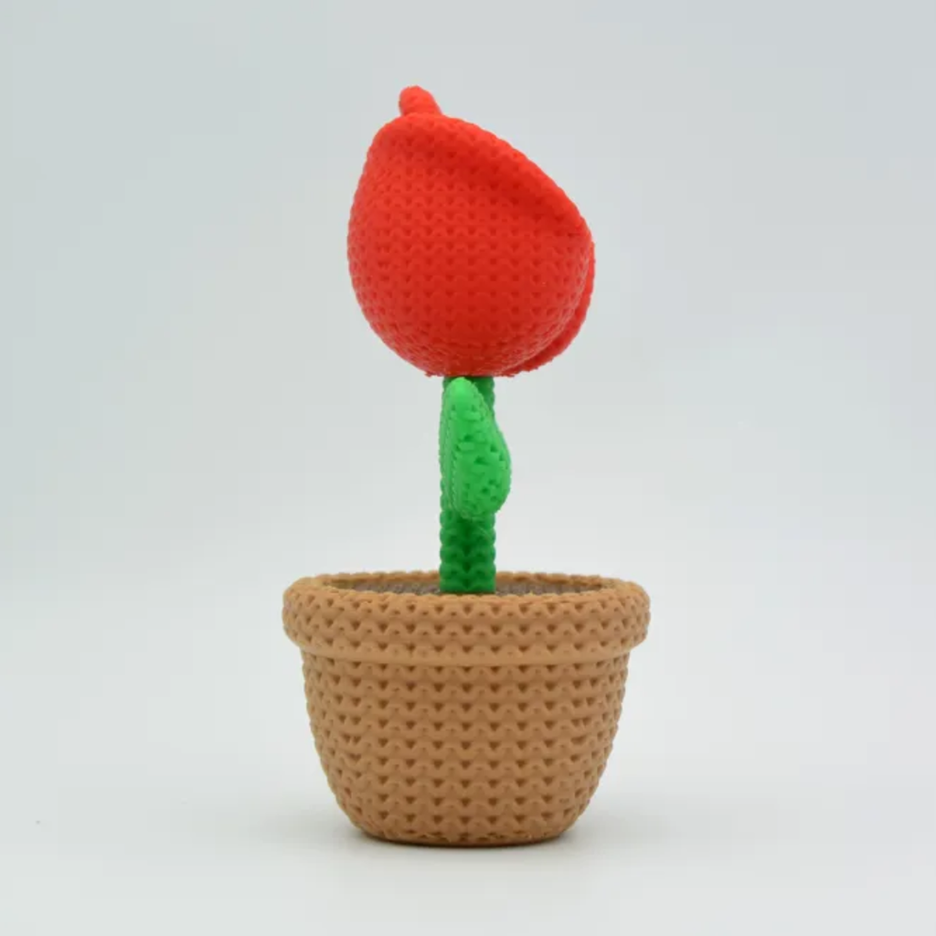 Crocheted red flower in a brown pot on a light gray background