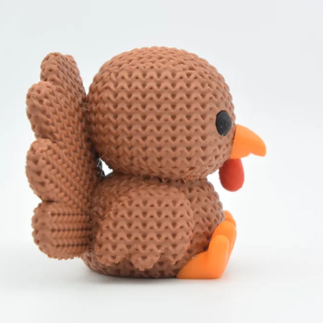 Brown textured toy duck with orange accents on a white background