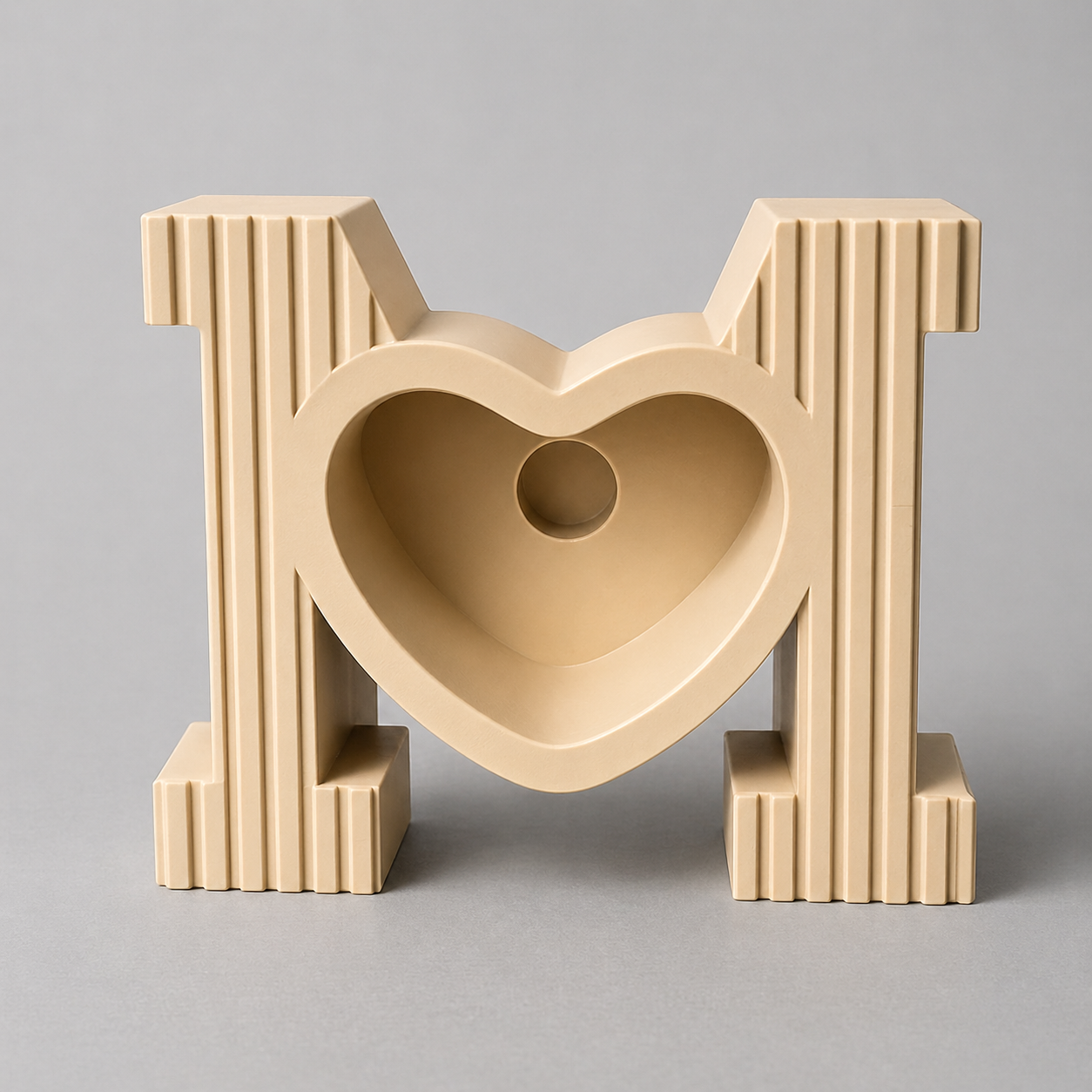 Beige heart-shaped object with vertical stripes on a gray background