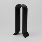 Black metal bookend on a light gray background