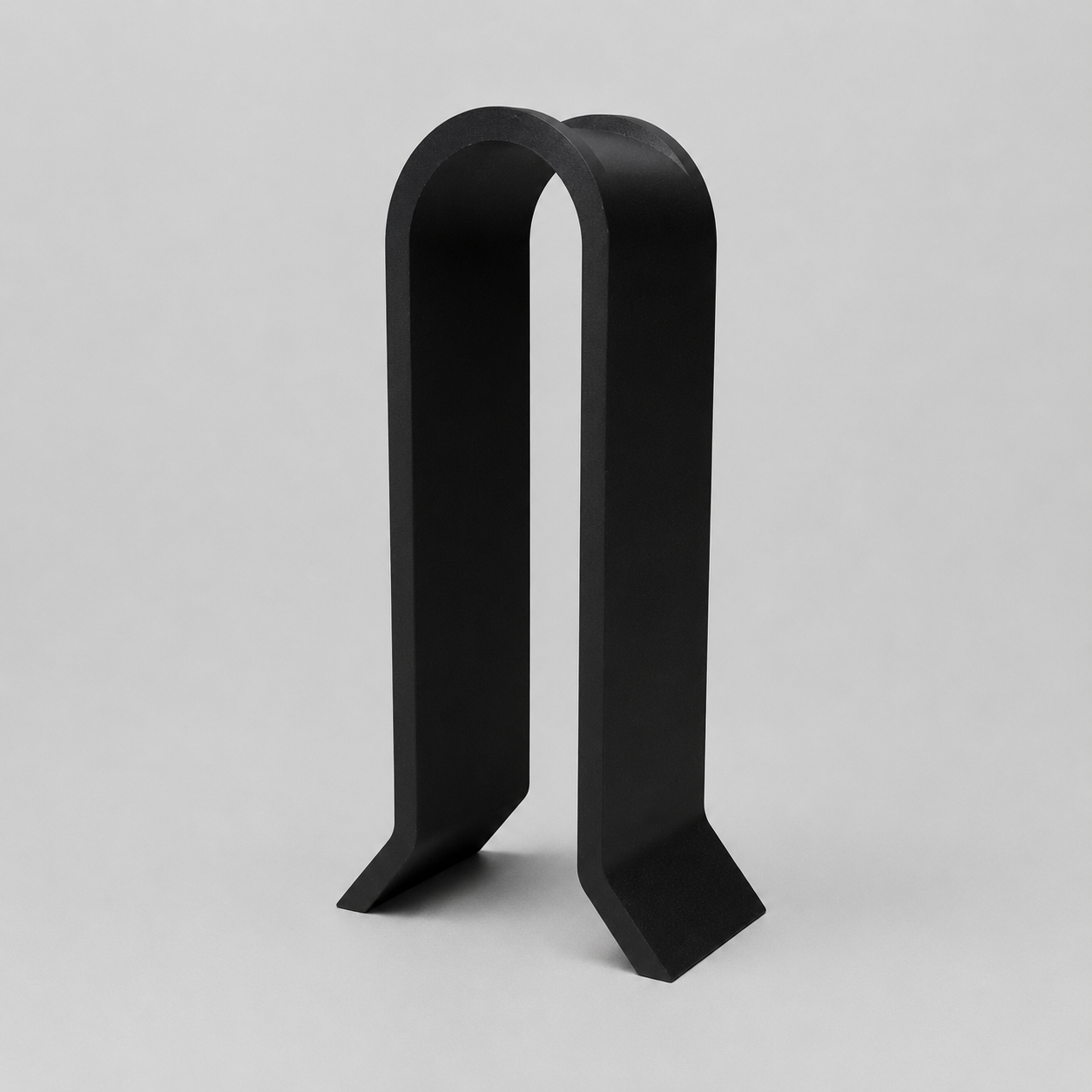 Black metal bookend on a light gray background