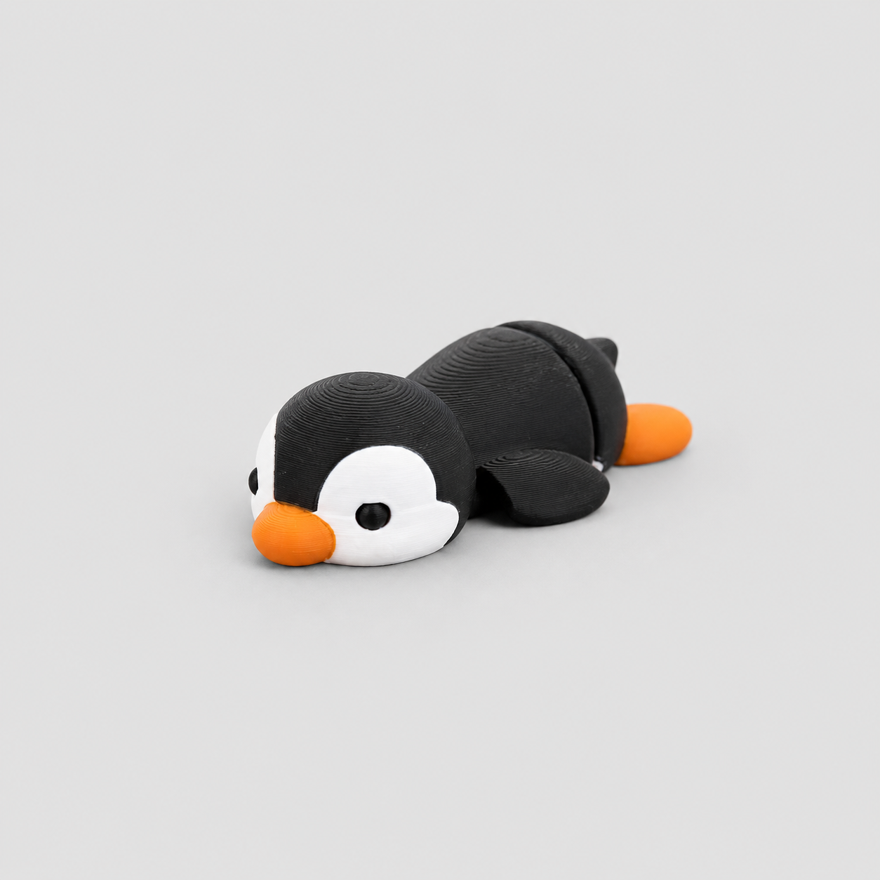 Teeny Penguin Figure in black and white with orange beak and feet, 3D printed