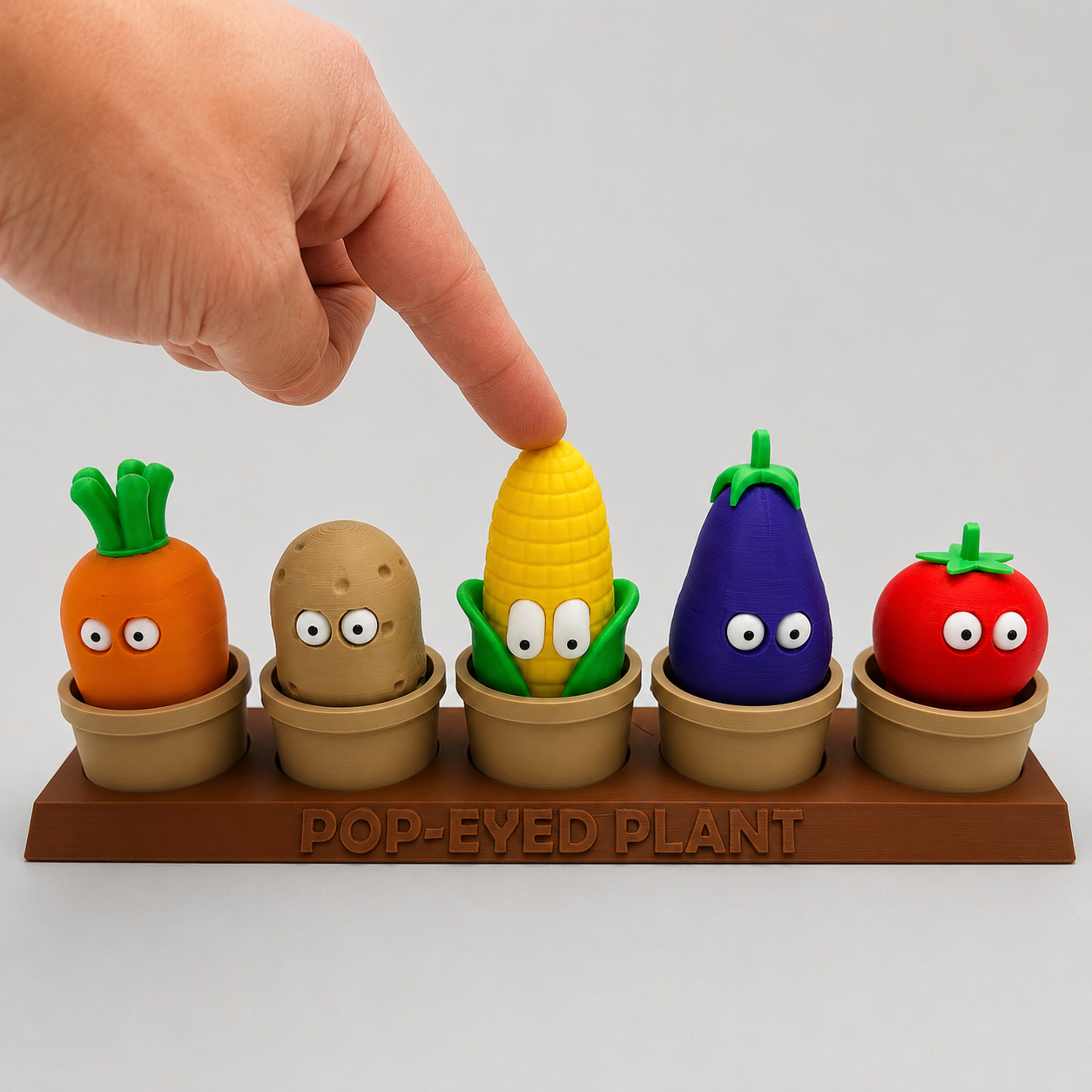 Pop-Eyed Tomato Plant Pot Family pressing
