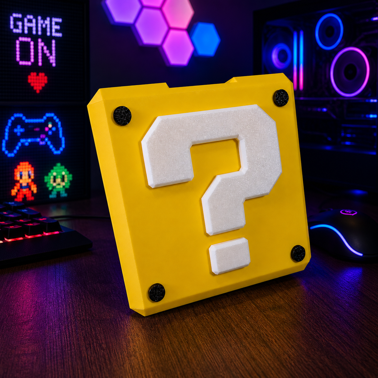 Yellow block with a white question mark on a desk in front of a computer setup with colorful lights.