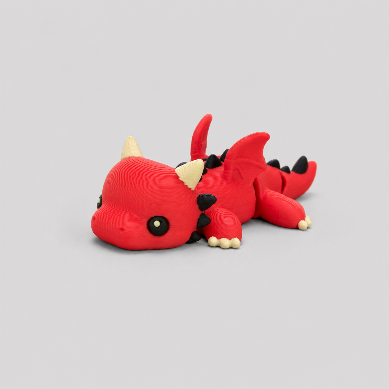 Teeny Dragon Figure in red with cream horns and black spines, 3D printed