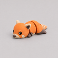 3D printed Teeny Red Panda figure in vivid orange with striped tail, lying down