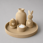 Set of beige ceramic decorative items including a vase, rabbit, eggs, and candle holder on a matching tray.