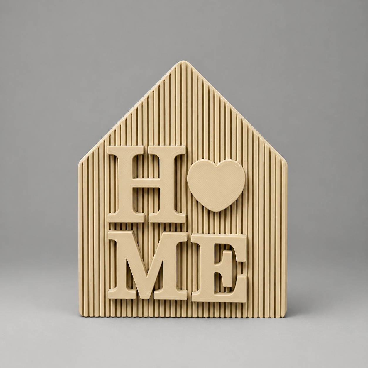 Beige house-shaped decorative item with 'HOME' text on a gray background