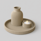 Beige textured vase and candle holder on a matching tray against a light gray background