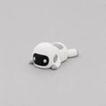 3D printed Teeny Robot figure in white with black visor and blue eyes, lying down
