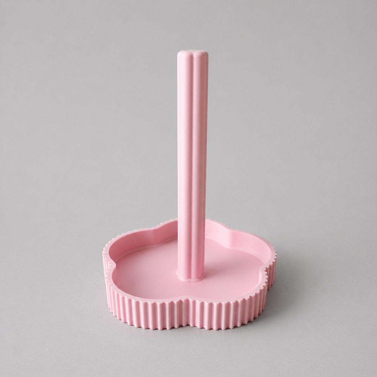 Pink stand with cylindrical holder on a gray background