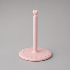 Pink paper towel holder with heart design on a gray background