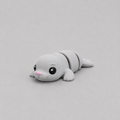 3D printed Teeny Seal figure in soft grey with pink nose, lying down