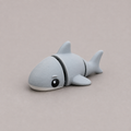 3D printed Teeny Shark figure in blue-grey with white underbelly, lying down