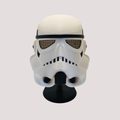 White and black Stormtrooper inspired wearable mask with mesh-style eyes, shown on a black display stand
