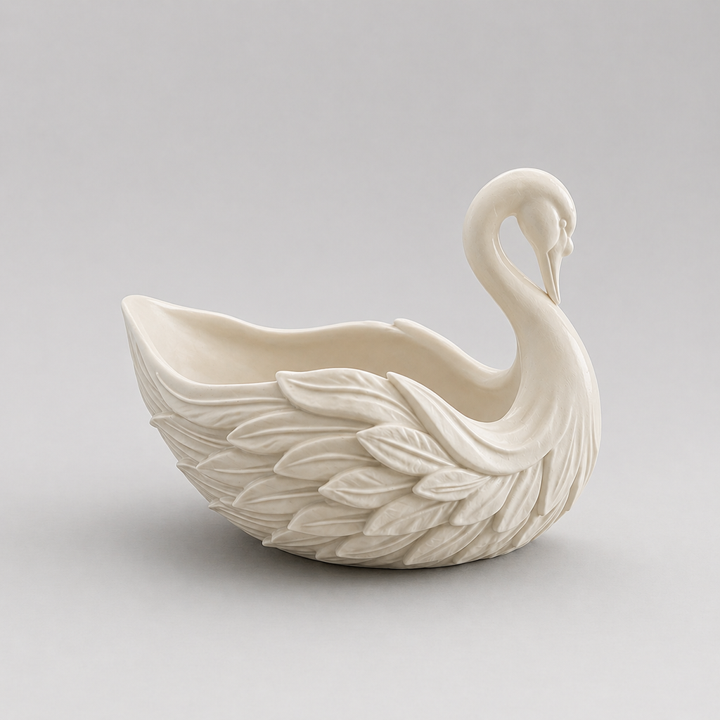 White ceramic swan-shaped vase on a light gray background