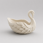 White ceramic swan-shaped vase on a light gray background