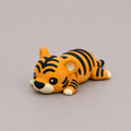 3D printed Teeny Tiger figure in bold orange with black stripes, lying down