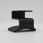 Black modern stool on a light gray background