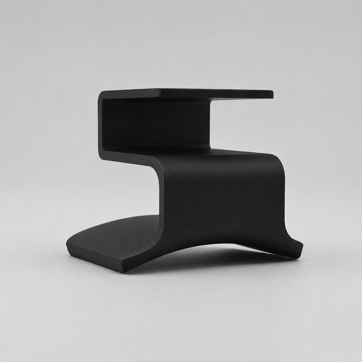 Black modern stool on a light gray background