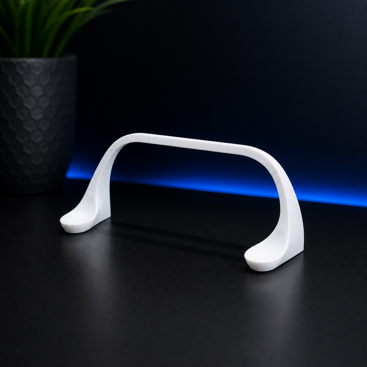 White electronic device with blue light on a dark surface